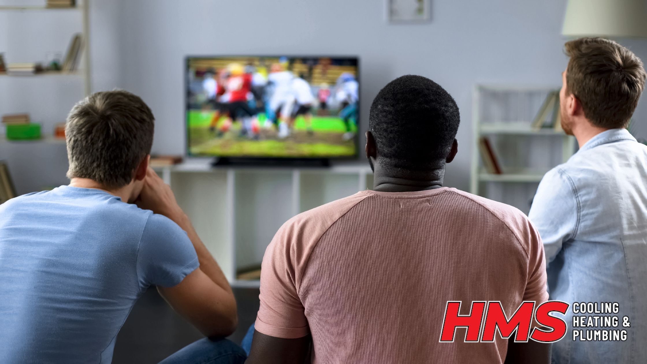 Friends cheering during a football watch party in a living room